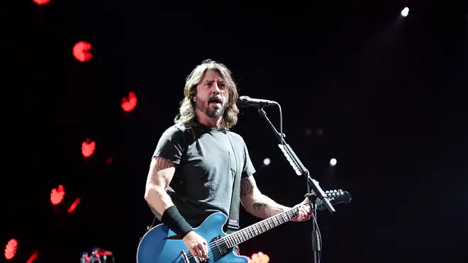 Foo Fighters' Dave Grohl shotguns beer with fan dressed as Santa