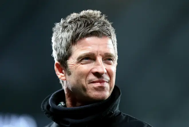 Noel Gallagher is interviewed before the match during the Premier League match between Manchester City and Manchester United at Etihad Stadium