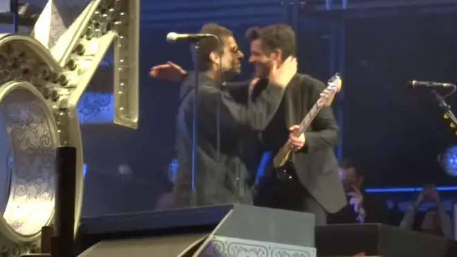 Liam Gallagher hugs The Killers' Brandon Flowers at Latitude 2018