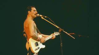 Freddie Mercury playing guitar during Queen's performance at the Rock in Rio festival, Brazil, January 1985.