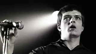 Ian Curtis performing live onstage with Joy Divison in Rotterdam