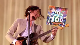 Arctic Monkeys' Alex Turner with Now That's What I Call Music 100 album inset