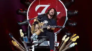 Dave Grohl takes the weight off his broken leg onstage in Amsterdam, 2015