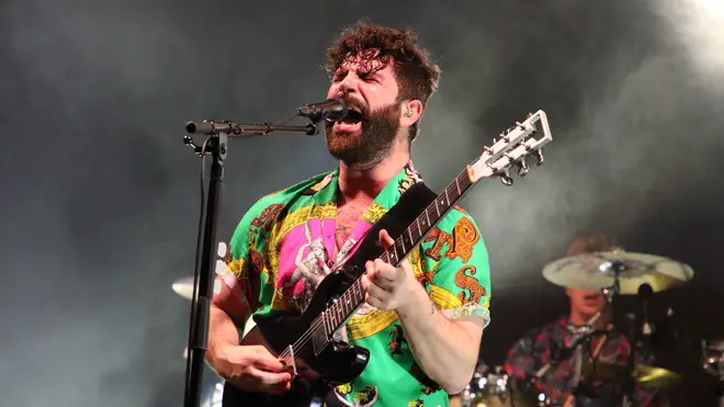Yannis on stage with Foals in July 2019