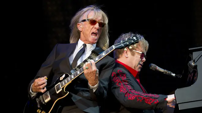 Davey Johnstone perfoms with Elton John onstage in 2012