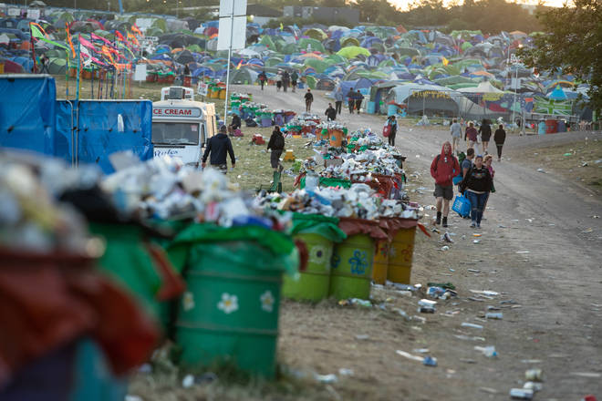 Festival goers leave the camp as clean up begins at the Glastonbury Festival at Worthy Farm in Somerset.