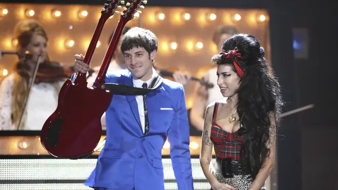 Mark Ronson performing on stage with Amy Winehouse at the BRIT Awards 2008
