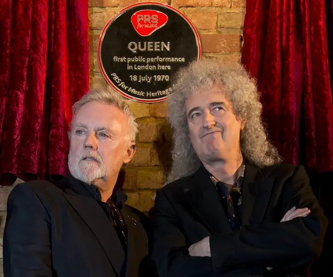 2013: Roger Taylor and Brian May pose with a plaque marking their first public gig at the Imperial College London Student Union on July 18,1970.
