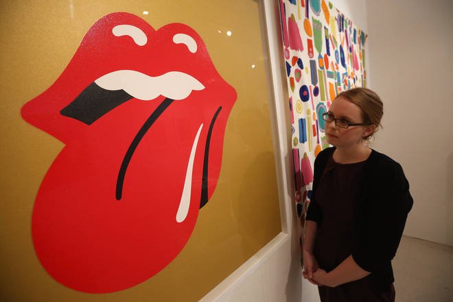 A woman views artwork by John Pasche entitled 'Rolling Stones logo' in the 'Perfect Place to Grow' exhibition at The Royal College of Art in celebration of their 175th anniversary on November 15, 2012