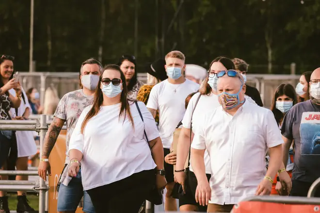 Fans enter the arena with face masks on