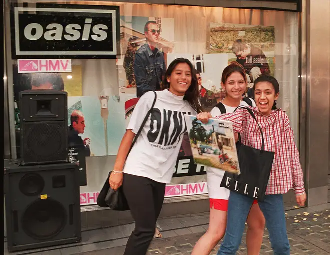 Happy Oasis fans pose with a Be Here Now vinyl on 21 August 1997