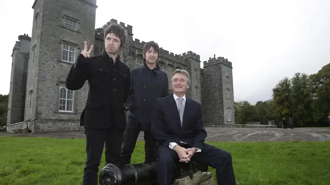 Noel Gallagher and Gem Archer pose with  Lord Henry Mountcharles outside Slane Castle in 2008