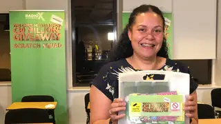 Listener Kate holds her winning scratch cards on The Chris Moyles show