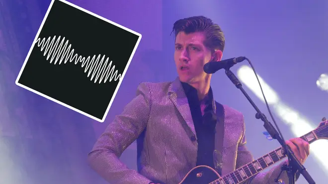 Alex Turner at Glastonbury Festival 2013 with Arctic Monkey's AM album artowork inset