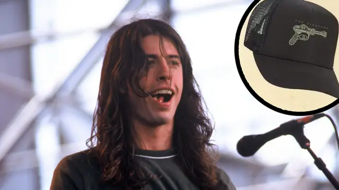 Dave Grohl performs in 1996 with image of the band's 25th anniversary merchandise inset