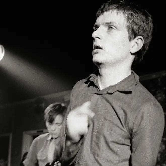 Bernard Sumner and Ian Curtis performing onstage as Joy Division in March 1979