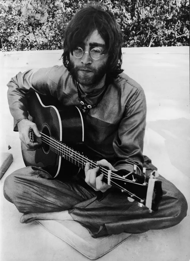John Lennon playing the guitar in Rishikesh, India in the Spring of 1968