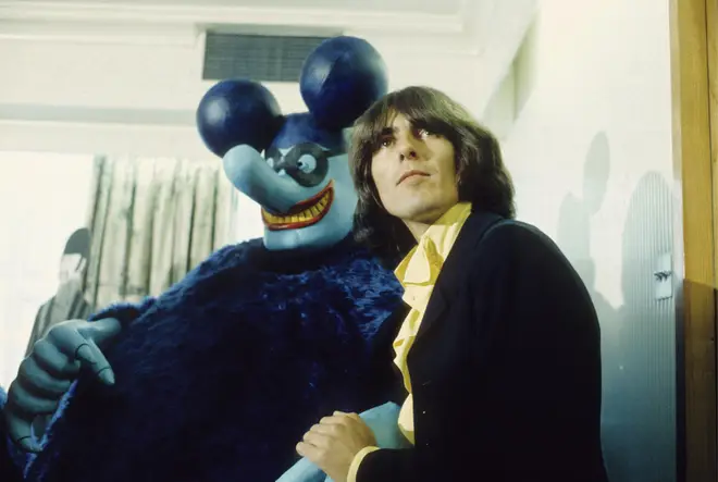 George Harrison with a Blue Meanie at the press screening of the film 'Yellow Submarine'