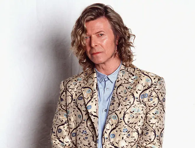 Bowie backstage at Glastonbury in his Alexander McQueen coat, June 2000