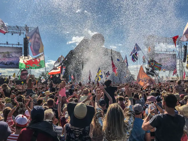 Somewhere in there, behind the confetti and the flags is Kylie Minogue, performing the Glastonbury legends slot in 2019