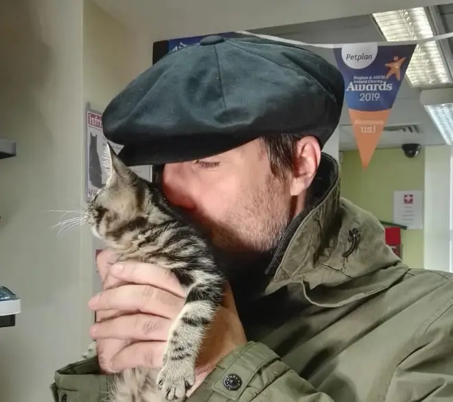 Liam Gallagher poses with his new kitten Sid at Wood Green, The Animals Charity