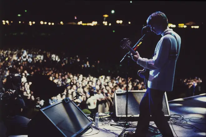 Noel Gallagher on stage at Knebworth, August 1996
