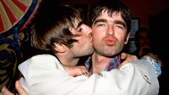Liam Gallagher giving brother Noel a kiss