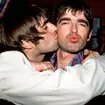 Liam Gallagher giving brother Noel a kiss.
