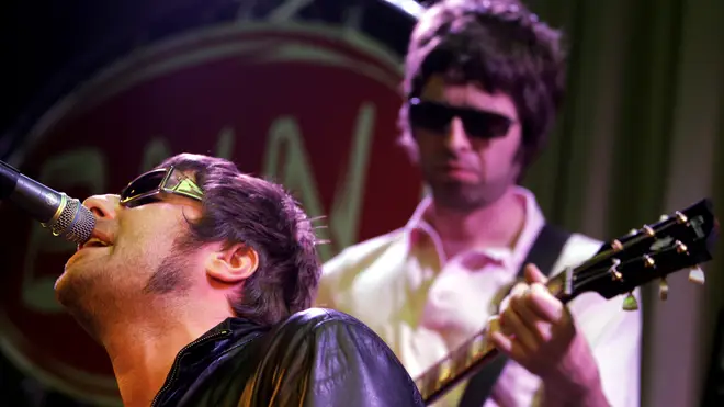 Noel and Liam Gallagher on stage together in Oasis. (Photo by Paul Bergen/Redferns)