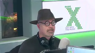 Dom wears glasses and a hat on The Chris Moyles Show