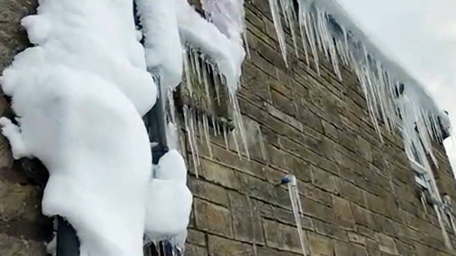 Bar manager Nicola shows us the icicles on the outside of the Tan Hill Inn, Yorkshire