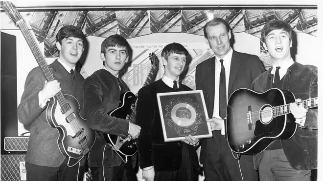 The Beatles receive their first ever silver disc for the single Please Please Me alongside their producer George Martin: 5 April 1963