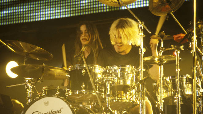 Alanis Morissette  performs onstage with Taylor Hawkins, circa 1995.