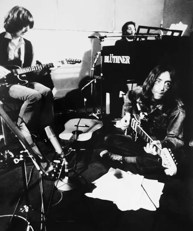 George Harrison, Paul McCartney and John Lennon performing Let It Be for the cameras in January 1969
