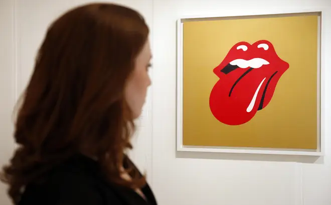 A woman views artwork by John Pasche entitled 'Rolling Stones logo' in the 'Perfect Place to Grow' exhibition at The Royal College of Art in celebration of their 175th anniversary on November 15, 2012