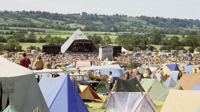 A general view of crowds in front of the original Pyramid stage at Glastonbury Festival in 1983.