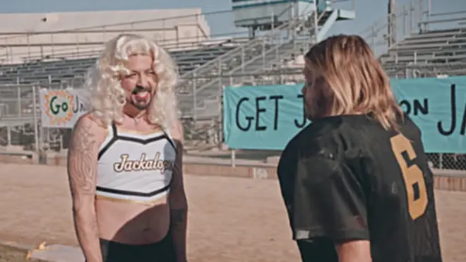 Foo Fighters' Dave Grohl dresses as cheerleeder and Taylor Hawkins dresses as football player in spoof video