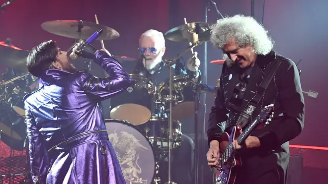 Adam Lambert sings with Queen drummer Roger Taylor and guitarist Brian May