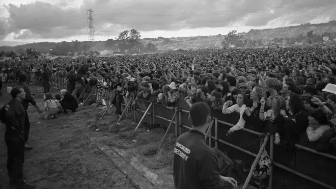 General view of the front rows of the crowd in front of the Pyramid Stage, Glastonbury Festival, United Kingdom, 1990.