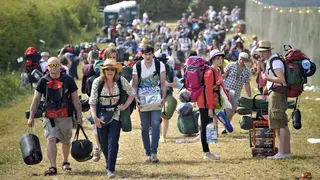 Festival goers arrive at Glastonbury in 2010
