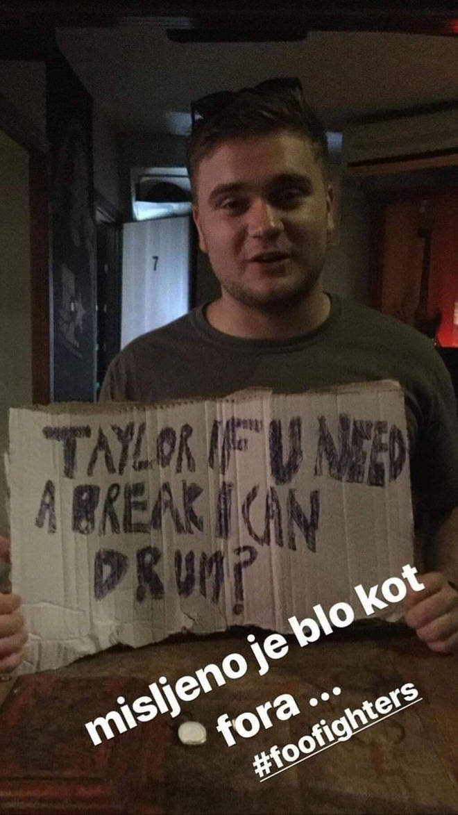 Foo Fighters fan Richard Greenbury holds up sign meant for Taylor Hawkins at their Croatia gig