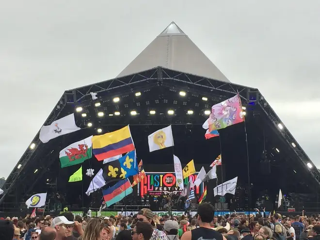 Flags fly in front of the Pyramid Stage at Glastonbury