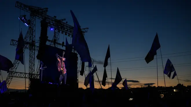 Fans watch Guns N'Roses at the Pyramid Stage at Glastonbury 2023