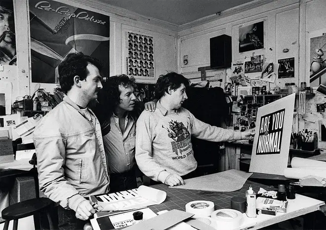 Peter Christopherson,Aubrey "Po" Powell and Storm Thorgerson survey the artwork for 10cc&squot;s Look Hear album in 1980