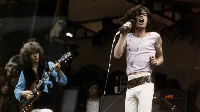 Mick Taylor and Mick Jagger performing live onstage at free Hyde Park concert