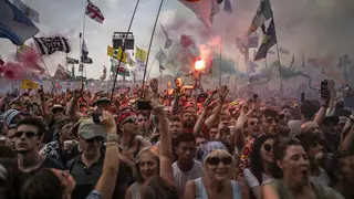 Glastonbury Festival-goers gather at the Pryramid Stage