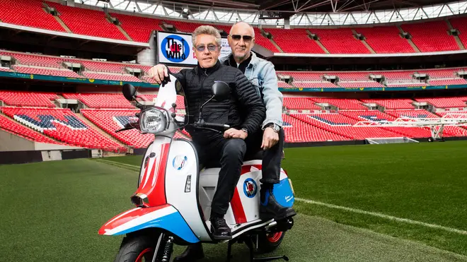 The Who's Roger Daltrey and Pete Townsend pose on a scooter in Wembley Stadium