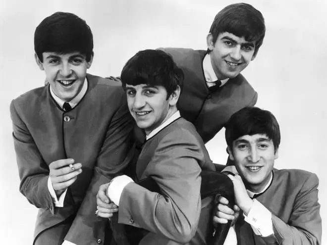 The Beatles in 1963, wearing their distinctive collarless Pierre Cardin suits.