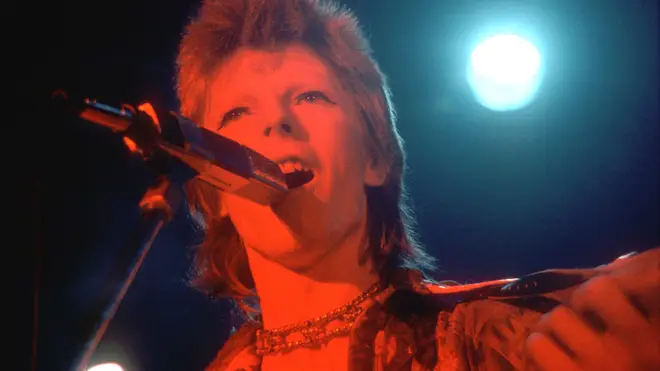 David Bowie performs onstage during his Ziggy Stardust era in 1973 in Los Angeles