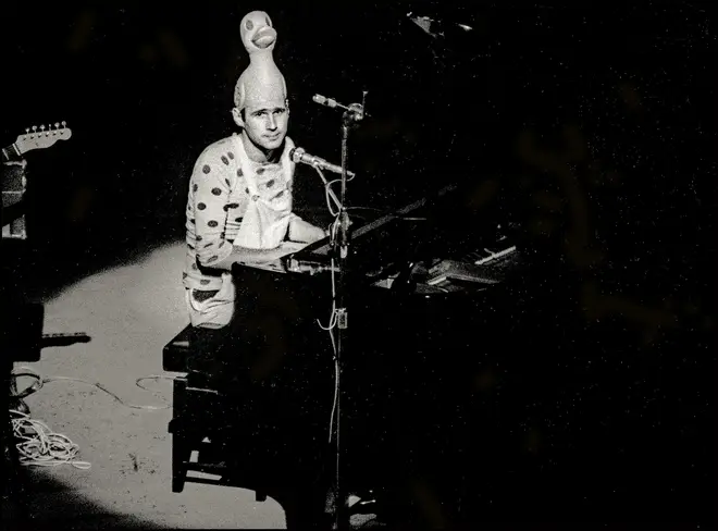 Neil Innes performs on stage in Victoria Palace, London in 1975